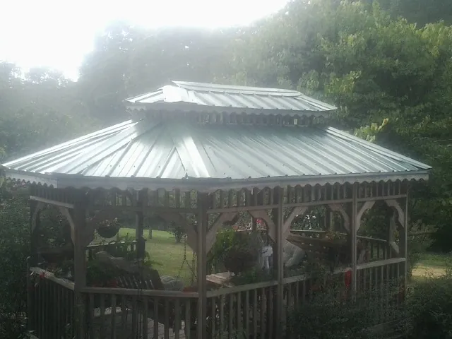 Two tier green metal roof on a garden gazebo in Buzzards Bay